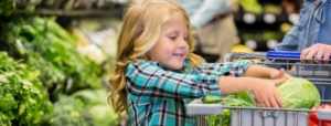 Child buying lettuce