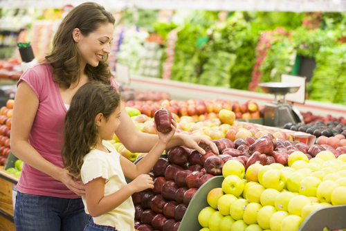 Mom and daughter picking out produce