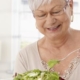 Older woman eating salad