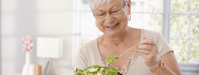 Older woman eating salad