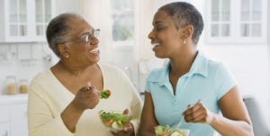 Mom and daughter eating produce